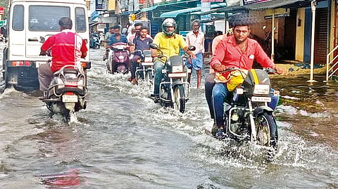 Vehicle wading through the flooded Sivathapuram Mani Road in Salem on Friday