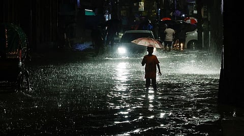 Boy wades through floodwater