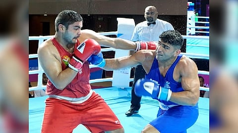 Boxer Sanjeet (blue) in action during the 36th National Games