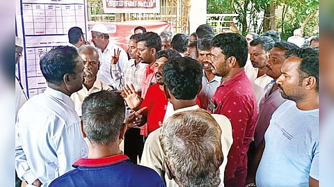 Residents arguing with officials and civic representatives at a gram sabha meeting in Tirupattur district.