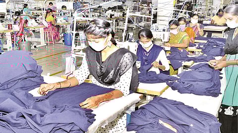 Workers packing garments at a textile unit in Tirupur