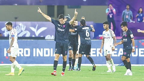 Odisha FC players celebrate after scoring the winning goal.