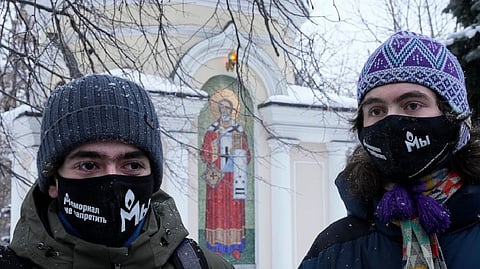 Supporters of the Memorial human rights group wearing face masks with the words "The Memorial cannot be banned!" gather in front of the Moscow Court in Moscow on Dec. 29, 2021.