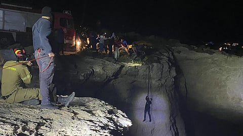 Authorities and local residents save a migrant during a large-scale rescue operation