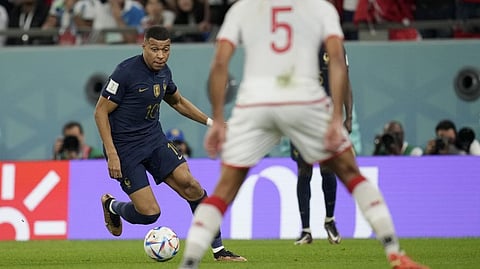 France's Kylian Mbappe runs with ball during the World Cup group D soccer match between Tunisia and France at the Education City Stadium in Al Rayyan, Qatar.