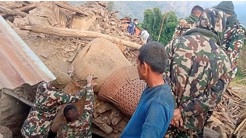 Members of the Nepal army work during a rescue operation at the ruins of a collapsed house, damaged after an earthquake struck early Wednesday, in the western district of Doti, Nepal.