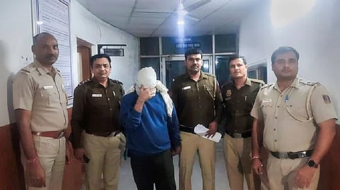 Police personnel along with accused Aftab Ameen Poonawala pose for the media, at Mehrauli Police Station, in New Delhi.