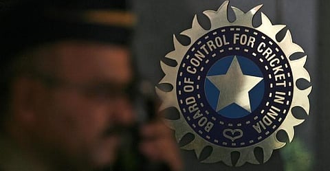 A policeman walks past a logo of the Board of Control for Cricket in India (BCCI) at BCCI headquarters in Mumbai