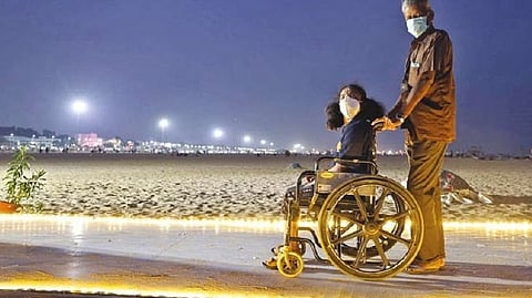 A physically disabled person taken for a stroll