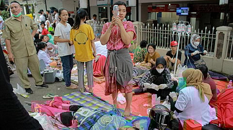 Earthquake survivors are treated outside of a hospital in Cianjur