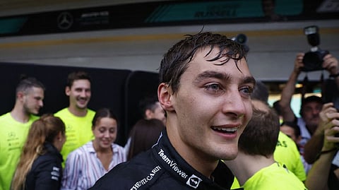 Mercedes' George Russell celebrates after winning the race