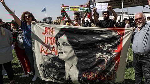 Protestors holding the banner featuring image of 22-year-old Mahsa Amini in Kurdistan, Iran
