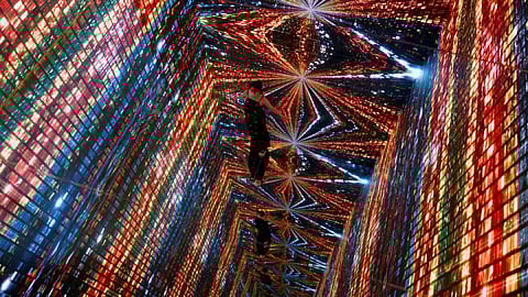 A visitor is pictured in front of an immersive art installation titled "Machine Hallucinations ? Space: Metaverse"