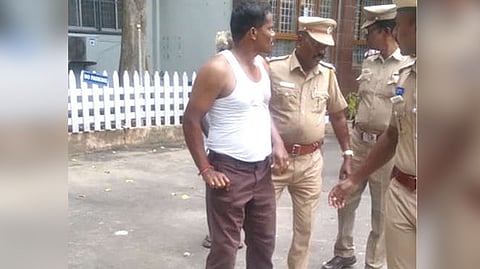 Police preventing farmer Dhanabal from immolating self at Tiruvallur Collectorate on Monday.