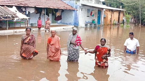 Anguished women standing in knee-deep water in their flooded locality in Erode on Tuesday