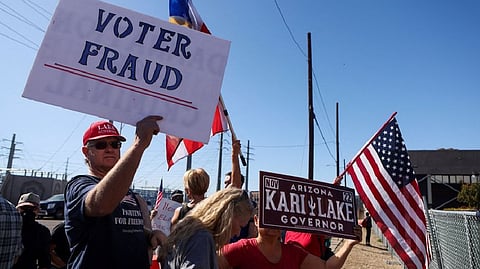 Supporters of Republican candidate for Arizona Governor Kari Lake and Republican U.S. Senate candidate Blake Masters protest outside the Maricopa County Tabulation and Election Center as vote counting continues inside, in Phoenix, Arizona.
