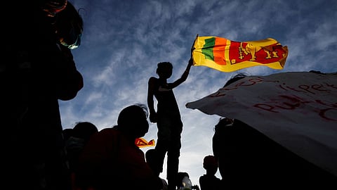 A demonstrator holding the Sri Lankan national flag