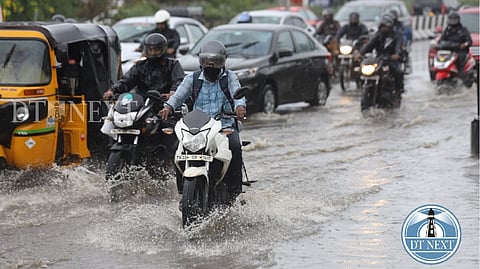 Bikes and cars driven through the flooded OMR