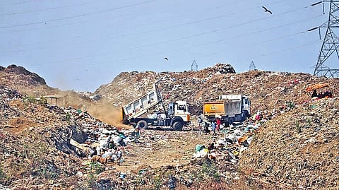 Trucks clearing garbage at Kodungaiyur dumpyard.