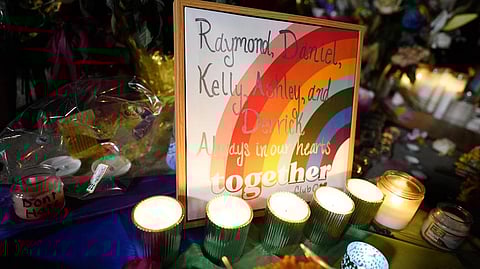 Names of the victims are shown on a rainbow during a candlelight vigil on a corner near the site of a weekend mass shooting at a gay bar, late Monday, Nov. 21, 2022, in Colorado Springs, Colo.