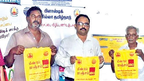 Tiruvallur Collector Dr Alby John Varghese with manjapai dispensed by the new machine.