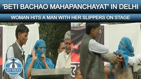 Woman hits a man with her slipper on stage