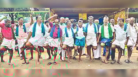 Farmers stand on single leg as part of ongoing protest against private mill for dues in Thanjavur on Saturday