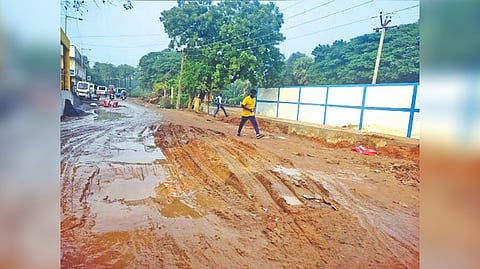 The potholed slippery Manali Main Road in Kodungaiyur.