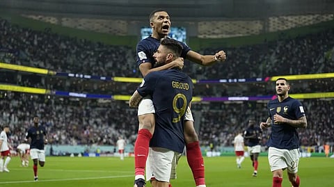 France's Olivier Giroud celebrates with France's Kylian Mbappe, after scoring the opening goal during the World Cup round of 16 soccer match between France and Poland, at the Al Thumama Stadium in Doha, Qatar, Sunday.