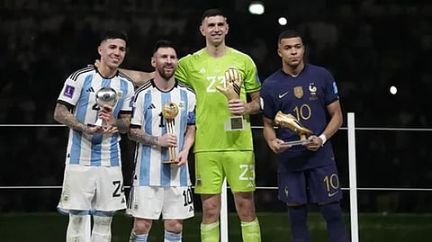 Argentina's Enzo Fernandez, goalkeeper Emiliano Martinez, Lionel Messi and France's Kylian Mbappe, from left to right, pose with their individual awards
