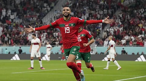 Morocco's Youssef En-Nesyri celebrates after scoring his side's first goal during the World Cup quarterfinal soccer match between Morocco and Portugal, at Al Thumama Stadium in Doha, Qatar