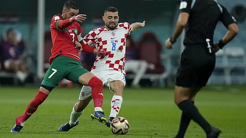 Morocco's Hakim Ziyech, left, and Croatia's Mateo Kovacic fight for the ball during the World Cup third-place playoff soccer match between Croatia and Morocco at Khalifa International Stadium in Doha, Qatar, Saturday.