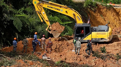 Rescuers work during a rescue and evacuation operation following a landslide at a campsite in Batang Kali, Selangor, Malaysia