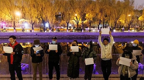 Vigil commemorating victims of a fire in Urumqi, in Beijing.