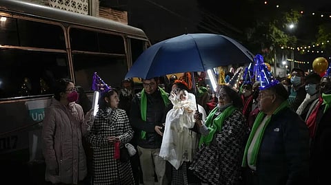 People carry the statue of baby Jesus