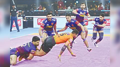 Dabang Delhi?s Amit Hooda tackles U Mumba?s Guman Singh.