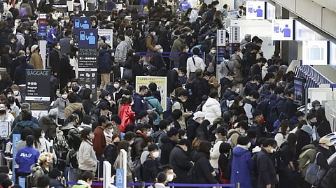 Travelers crowd at a departure lobby of Haneda airport in Tokyo Thursday, Dec. 29, 2022. Japan on Thursday reported a record 420 single-day coronavirus deaths, one day after reaching an earlier record of 425 deaths, according to the Health Ministry.