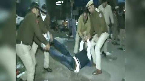 Police detaining the protestors in Delhi.