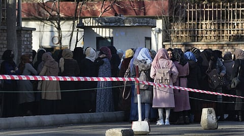 Afghan students line up at one of Kabul University's gates in Kabul, Afghanistan.