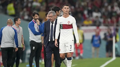 Portugal's Cristiano Ronaldo, center, passes beside his coach Fernando Santos as he leaves the field during the World Cup group H soccer match between South Korea and Portugal, at the Education City Stadium in Al Rayyan.