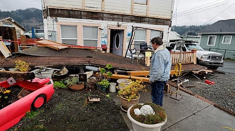 Homeowner Darren Gallagher looks at the collapsed second story porch of his house after a strong 6.4-magnitude earthquake struck off the coast of northern California