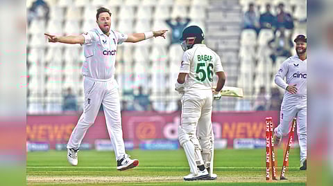 England?s Ollie Robinson celebrates after taking the wicket of Pakistan?s Babar Azam