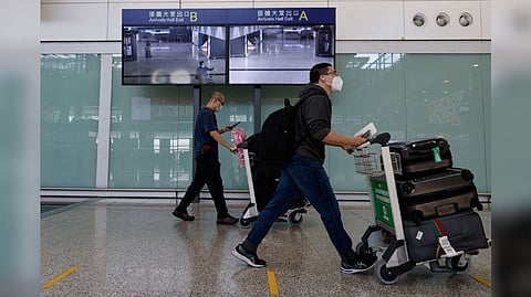 Travellers arrive at the Hong Kong International Airport on the first day the COVID hotel quarantine has been scrapped, in Hong Kong, China