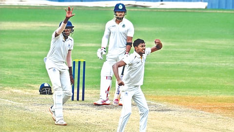 Ajith Ram celebrates one of his five wickets against Assam