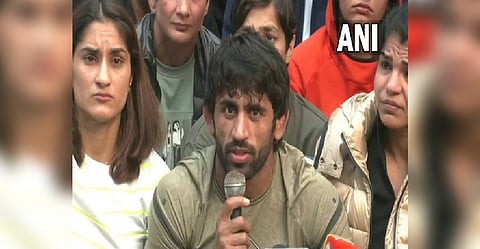 Bajrang Punia, Vinesh Phogat and Sakshi Mallik addressing the media