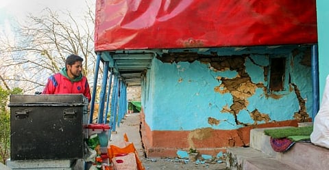 A resident shows cracks that appeared in a house in Joshimath