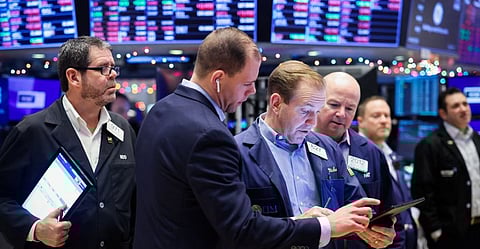 Traders work on the trading floor at the New York Stock Exchange (NYSE) in New York City