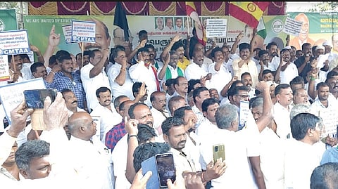 Members of various trade and service associations protesting near Paranur toll plaza in Chengalpattu on Wednesday