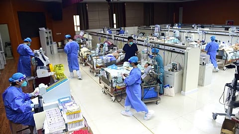Medical workers attend to patients of the coronavirus disease at an intensive care unit (ICU) converted from a conference room, at a hospital in China