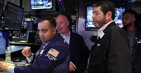 Traders work at the post where Carvana Co. is traded on the floor of the New York Stock Exchange (NYSE) in New York City